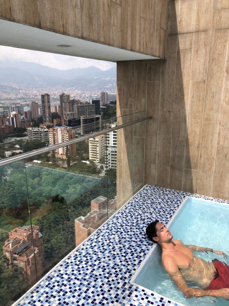Man relaxes in pool in Medellin property