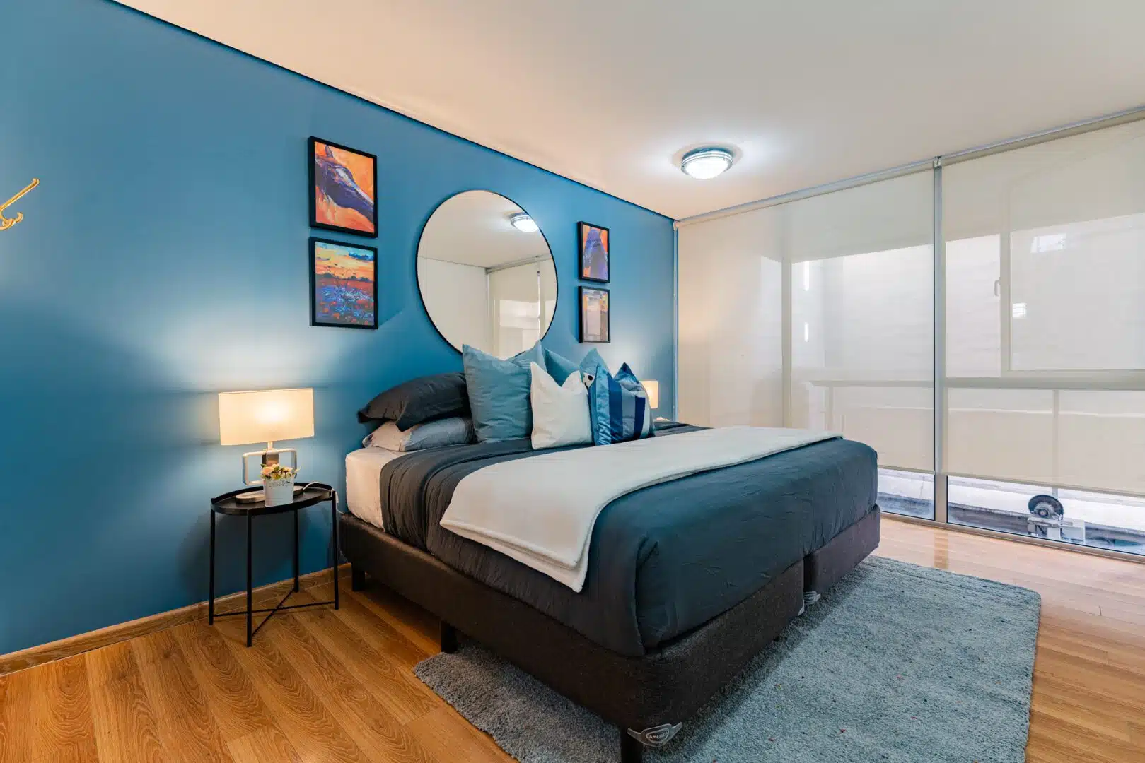 Premium master bedroom interior featuring a large bed and panoramic window views at Apto San Luis Mexico City.