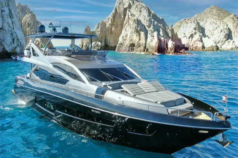 Sleek black and silver luxury performance yacht cruising on blue waters at Sunseeker Cabo San Lucas.