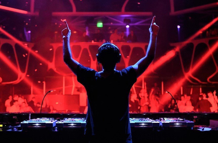 DJ performing at a luxury private party with guests dancing and premium lighting