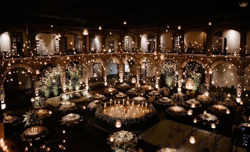 Spectacular night wedding reception glowing with warm golden lights across a massive courtyard at Ex Convento de San Hipolito Mexico City.