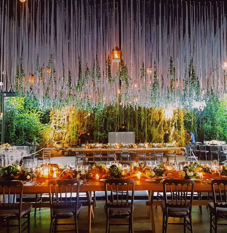 Extravagant night wedding reception dinner with thousands of hanging white strings over tables at Jardin Lomas Altas Mexico City.