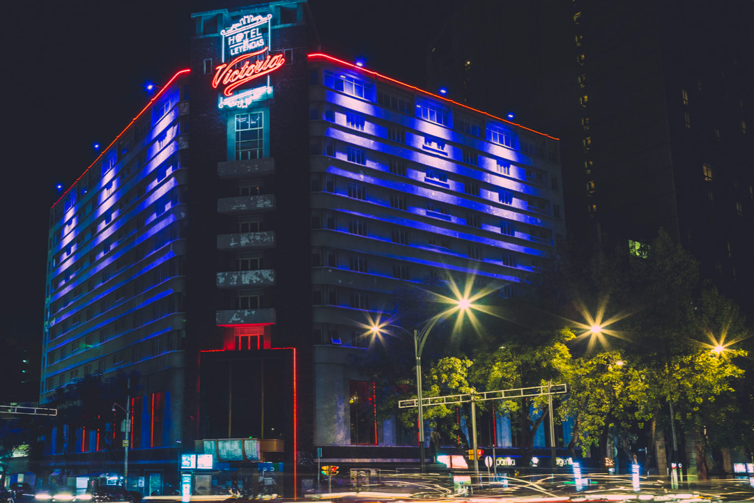 Exterior urban night view of the illuminated building facade of Hotel Reforma Mexico City.