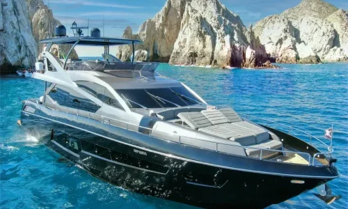 Sleek black and silver luxury performance yacht cruising on blue waters at Sunseeker Cabo San Lucas.